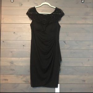 Cache mid length dress with beaded detail.